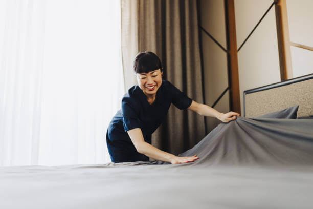 Maid Services Cleaning in Dubai: Deep Cleaning vs. Regular Cleaning maid cleaning bedsheet